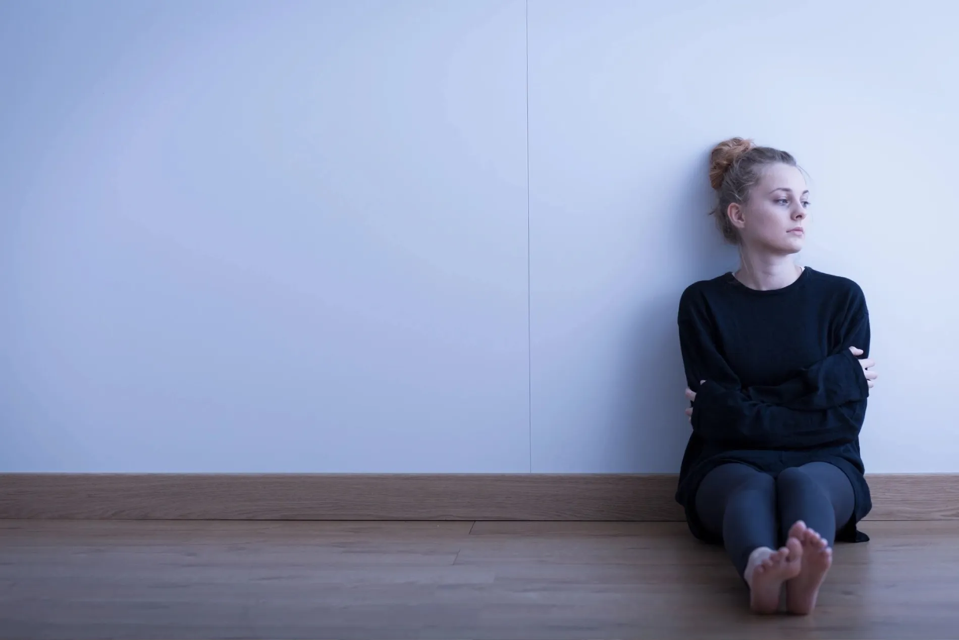 a woman in black top looking sad